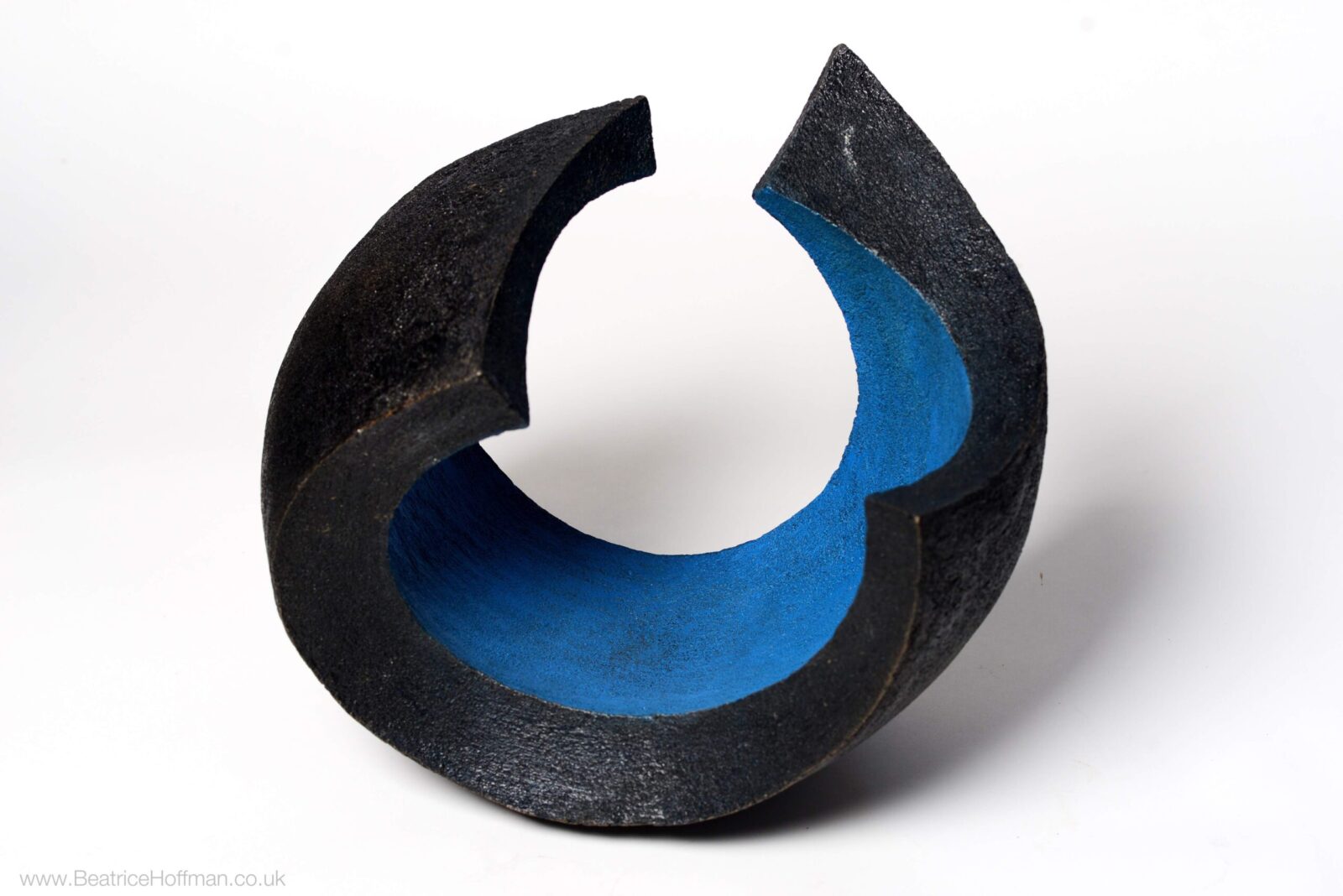 Abstract circular garden bronze sculpture coloured blue and black