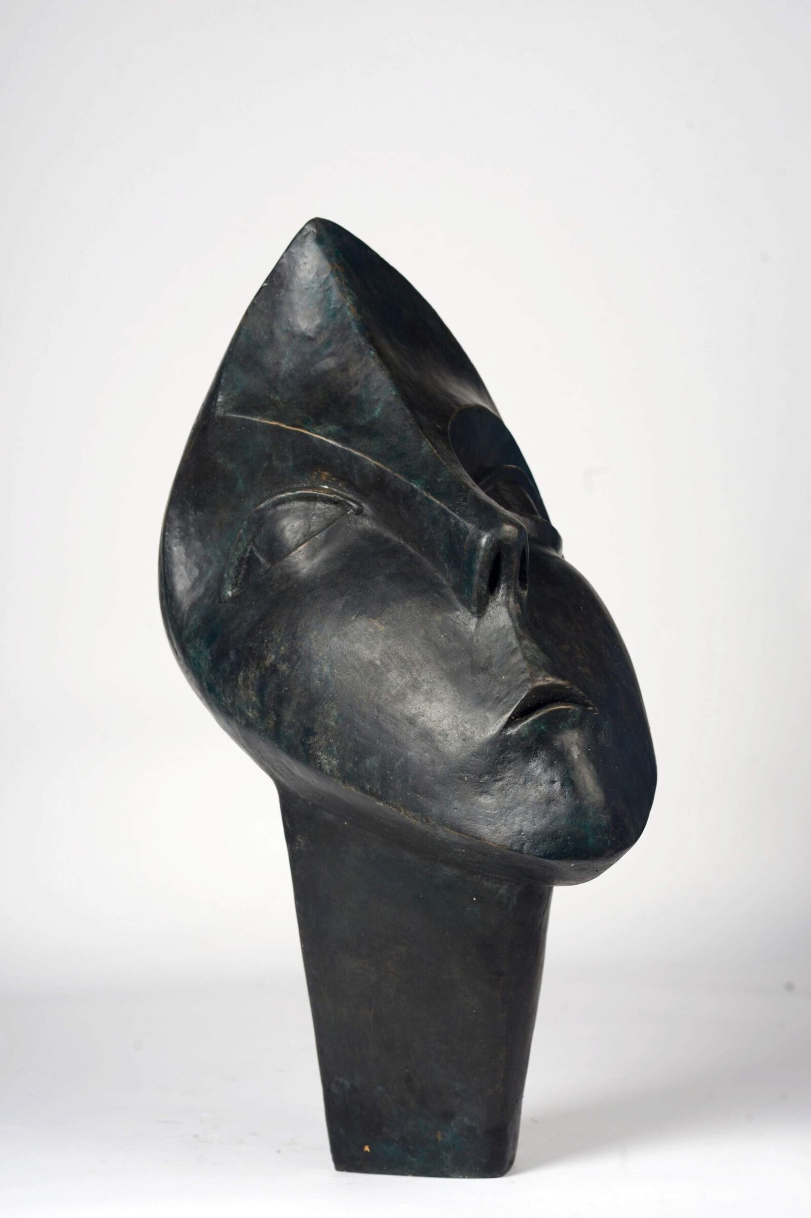 contemporary bronze sculpture of a head based on African carving