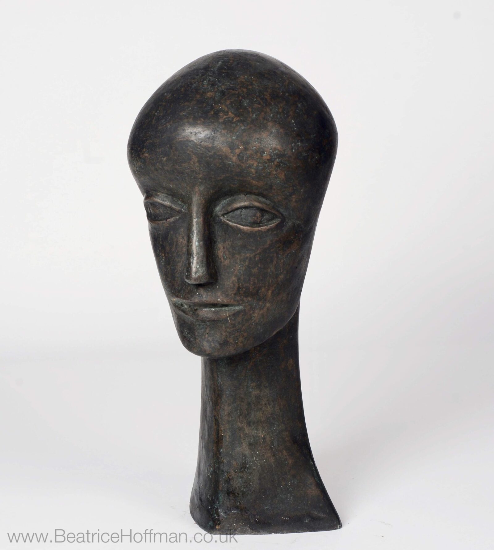 contemporary bronze sculpture of a head based on early medieval church sculpture