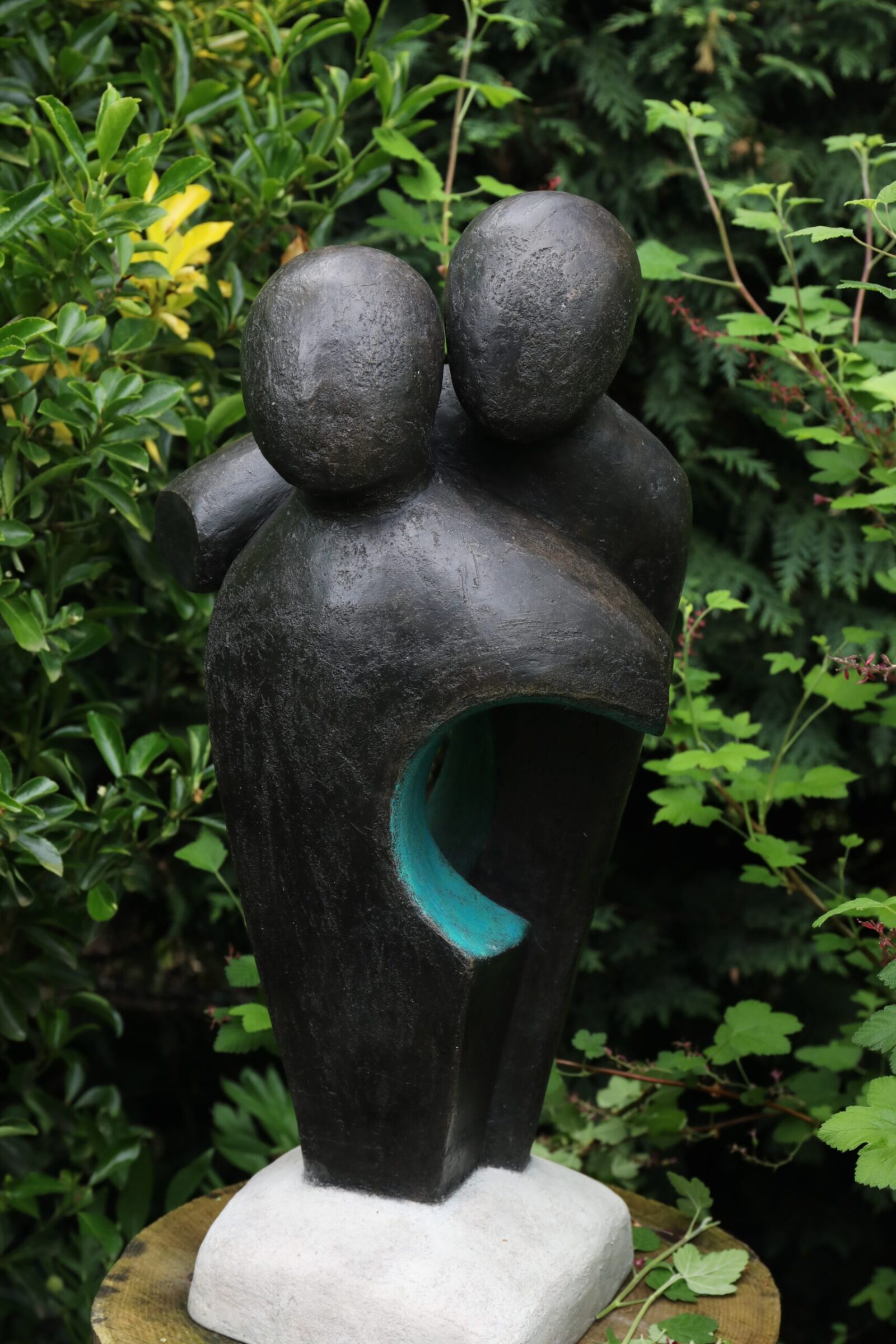 contemporary bronze sculpture of a couple in the garden