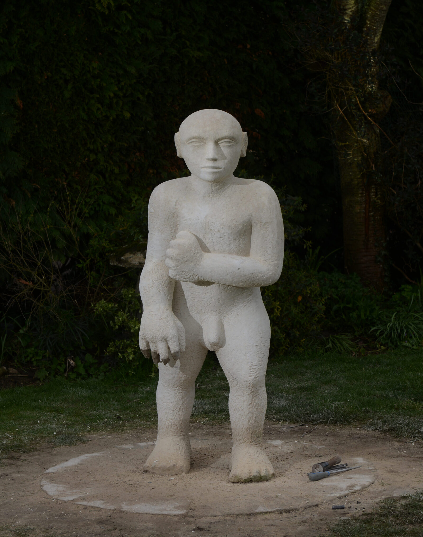 modern life size stone carving of a man
