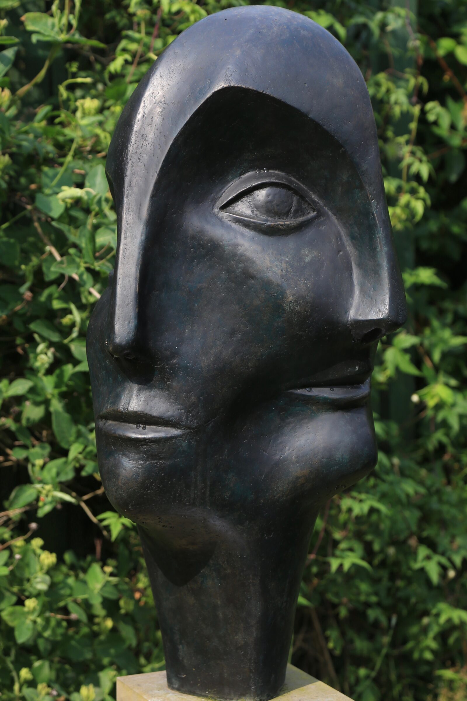 modernist bronze sculpture of head inspired by Picasso for the garden