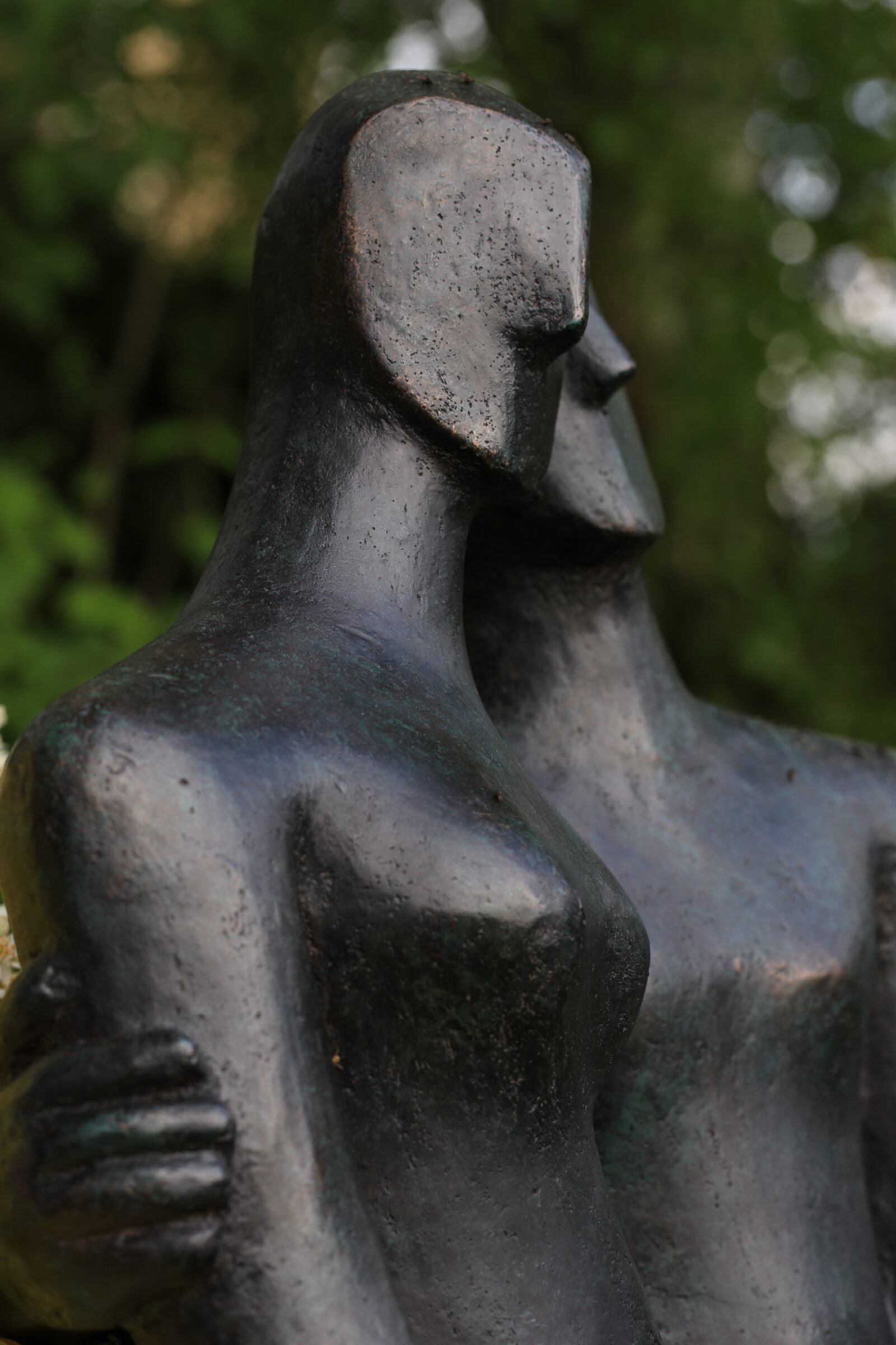 detail of modern bronze sculpture of a couple