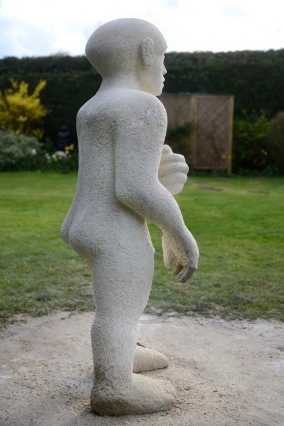 Unfinished modern Lime stone sculpture of a nude man in the process of walking forward
