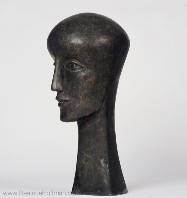 contemporary bronze sculpture of a head based on early medieval church sculpture