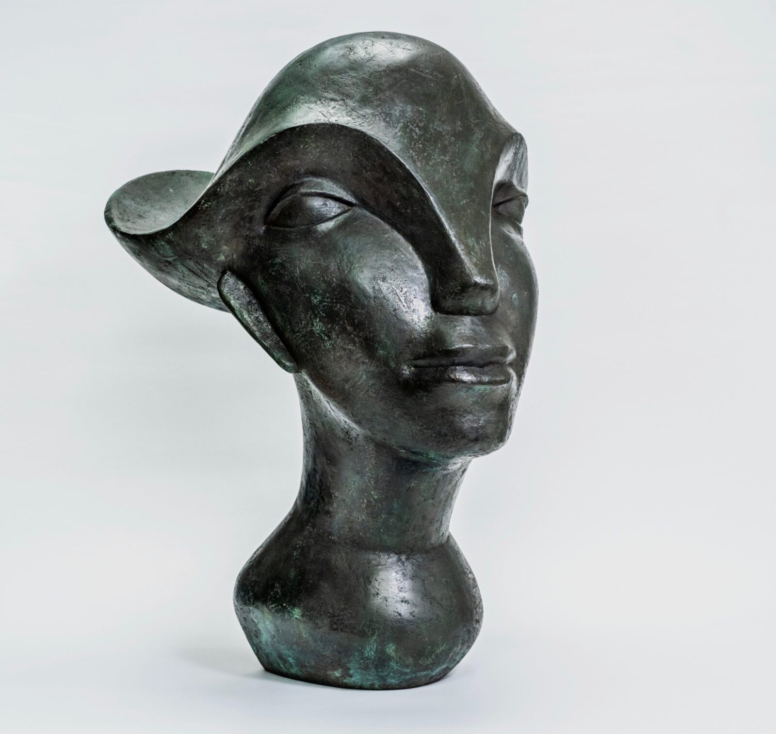 contemporary bronze sculpture of a female head with flowing hair