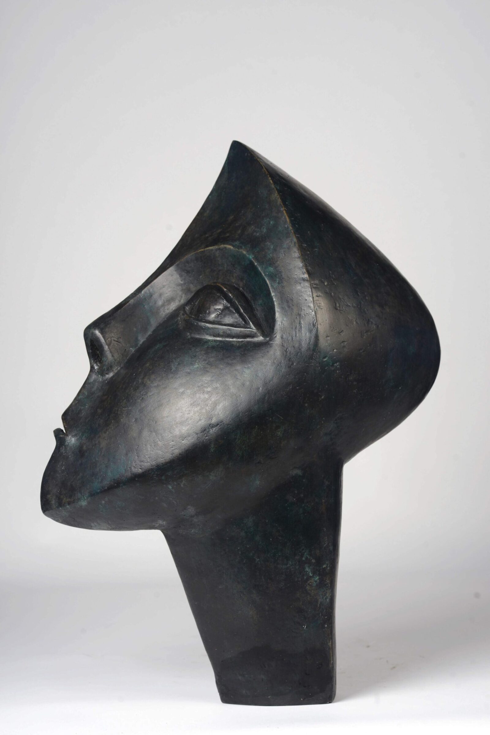 contemporary bronze sculpture of a head based on African carving