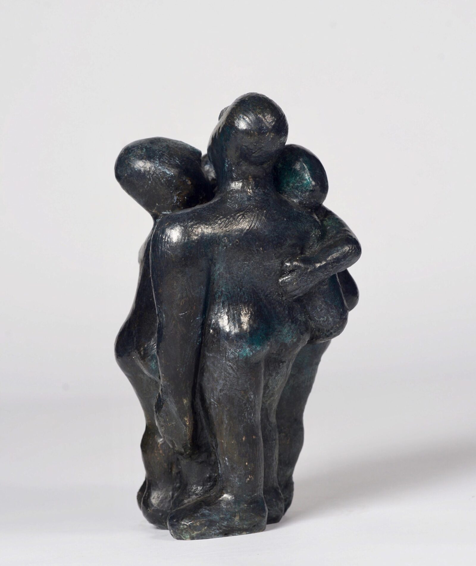 small modern bronze sculpture of a close group of huddled figures