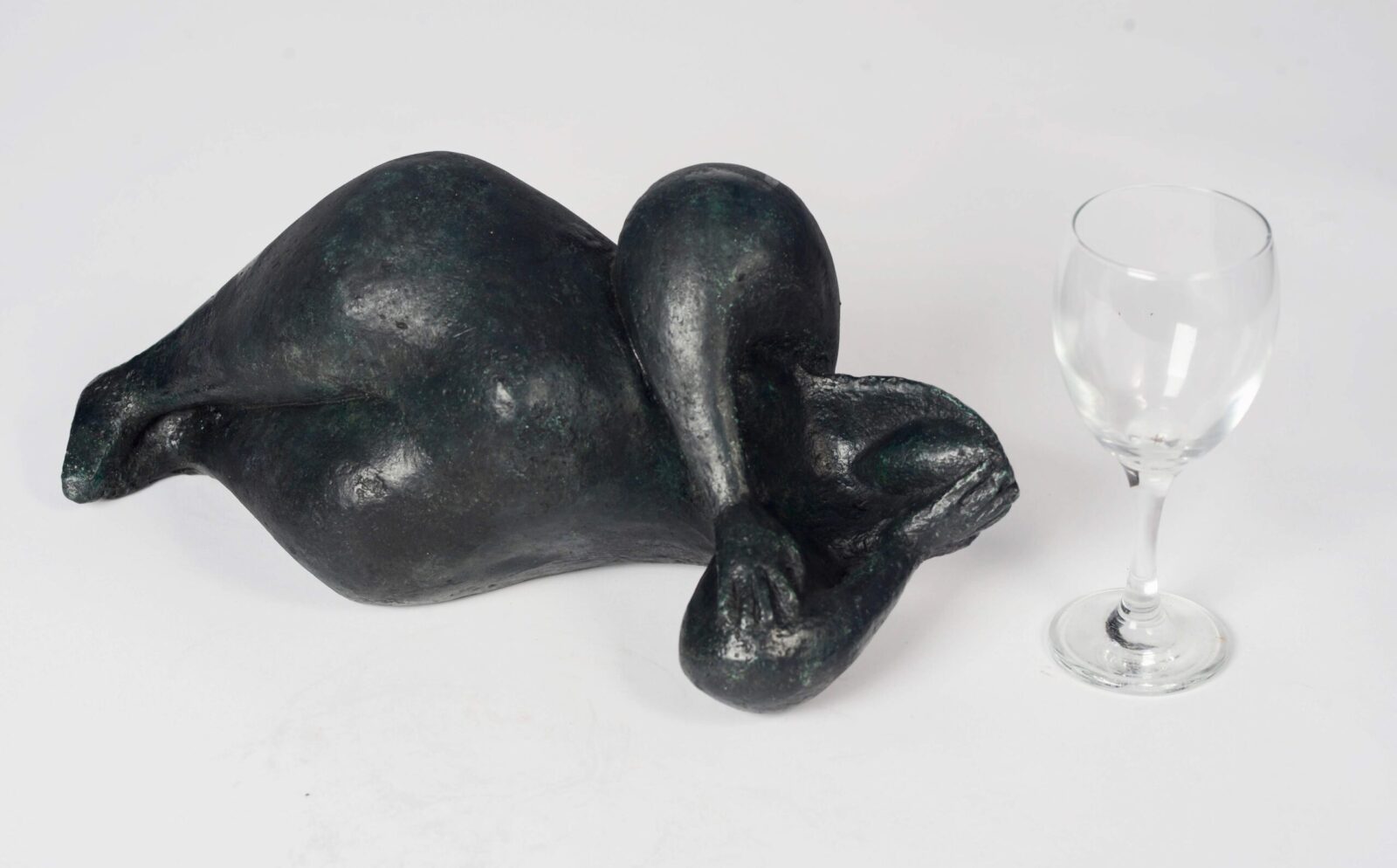 modern bronze sculpture of a lying ample nude for the home