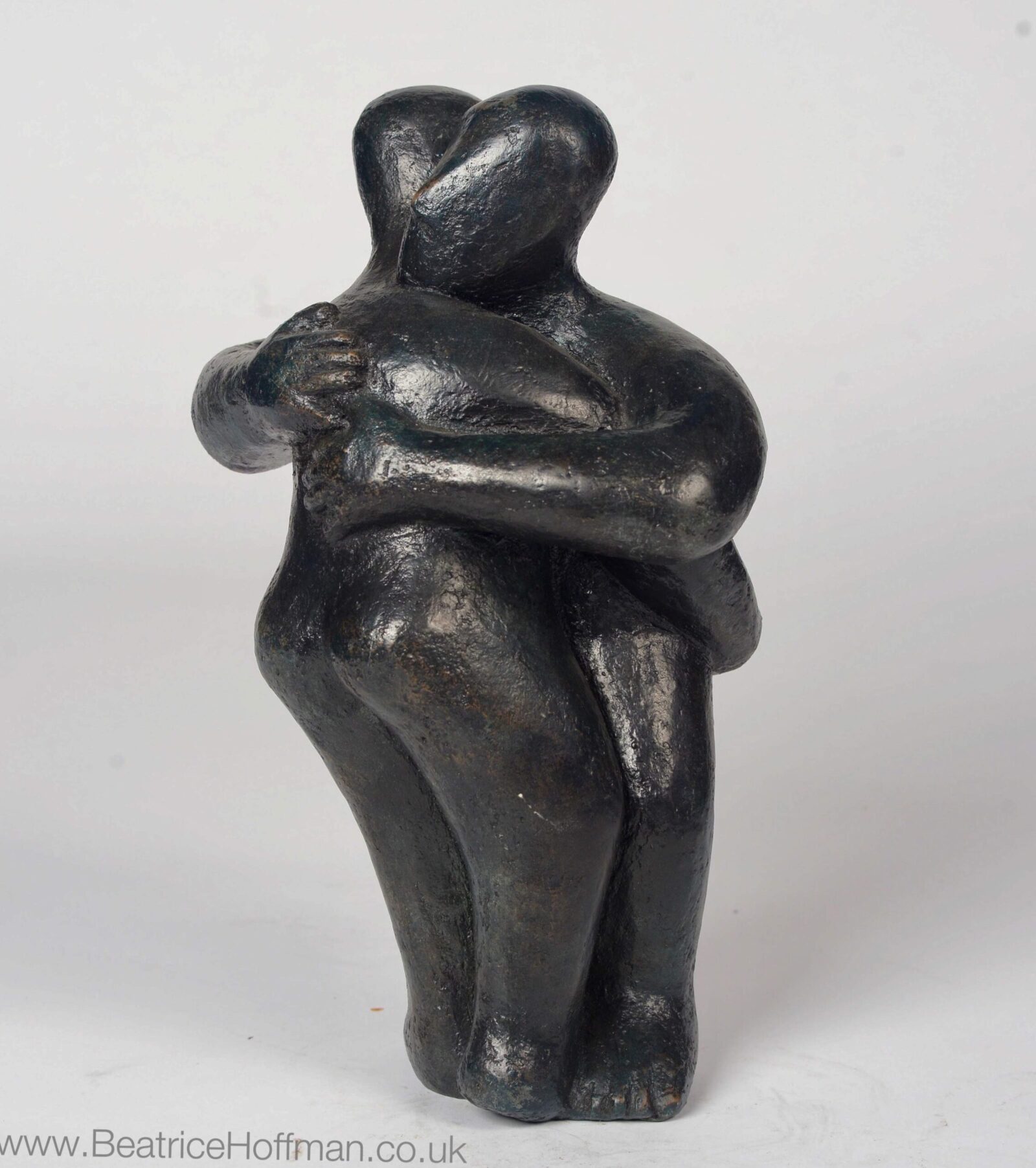 modern affectionate bronze sculpture of a couple for a wedding anniversary
