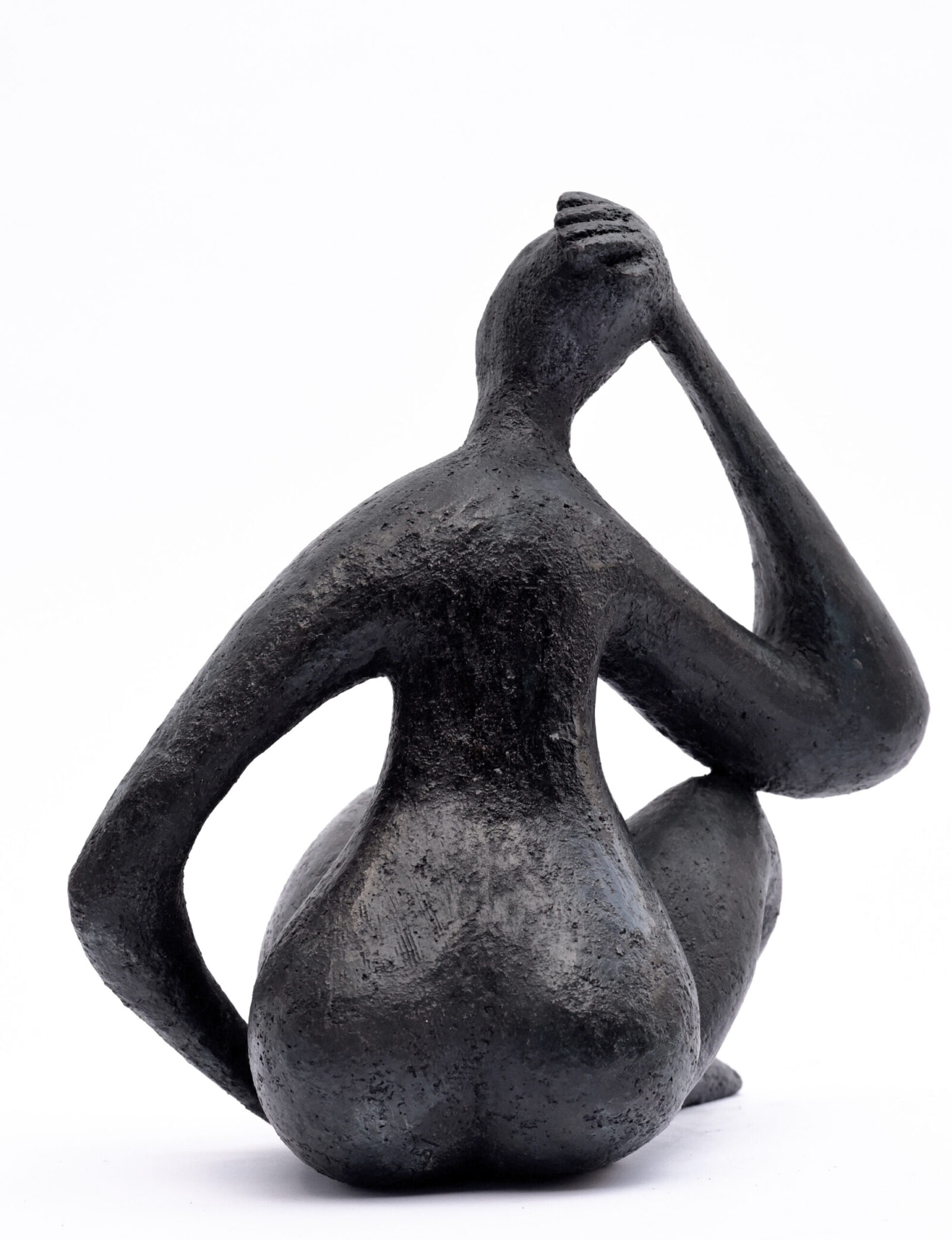 elegant contemporary bronze sculpture of a sitting figure for interior design