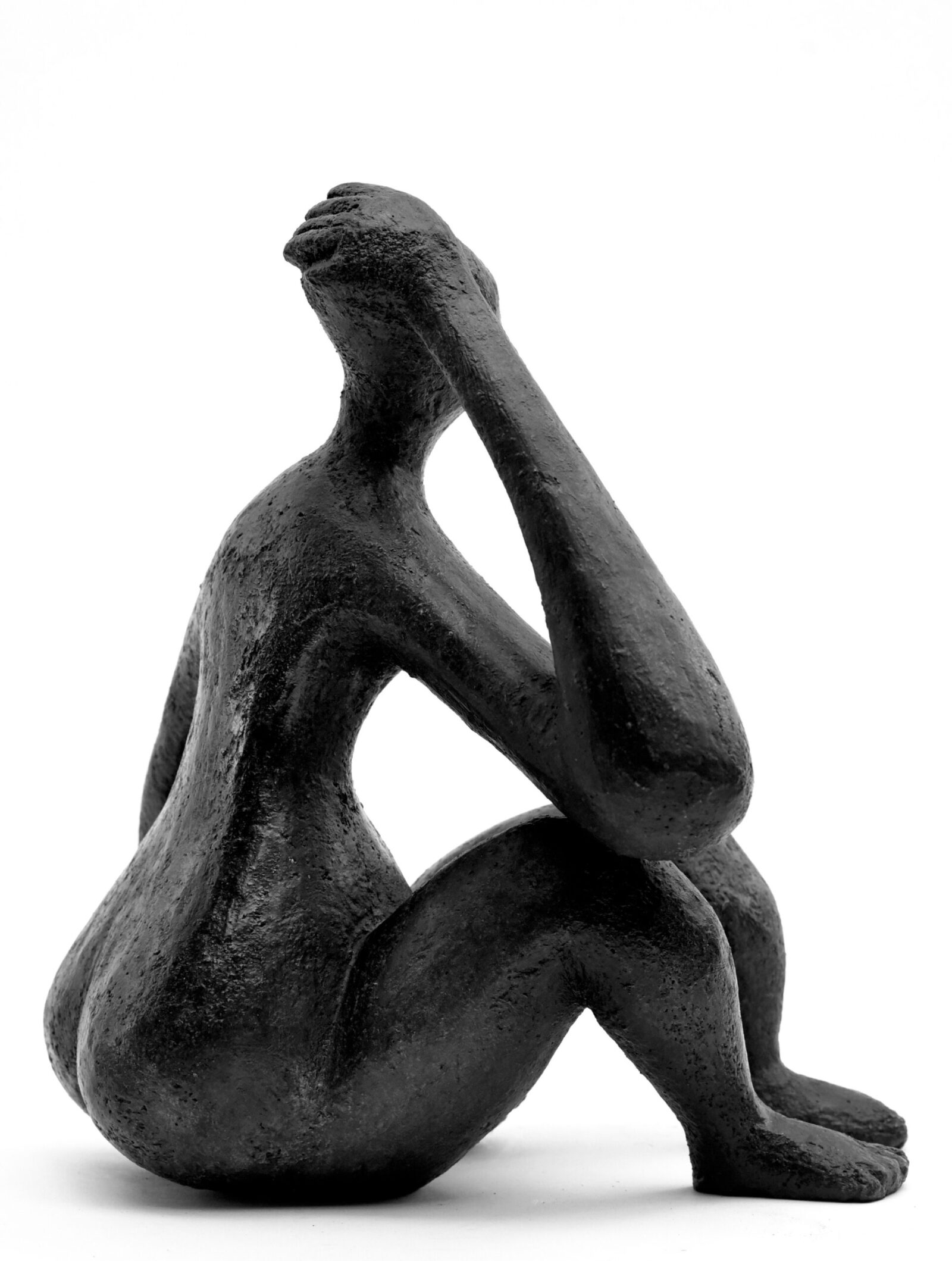elegant contemporary bronze sculpture of a sitting figure for interior design