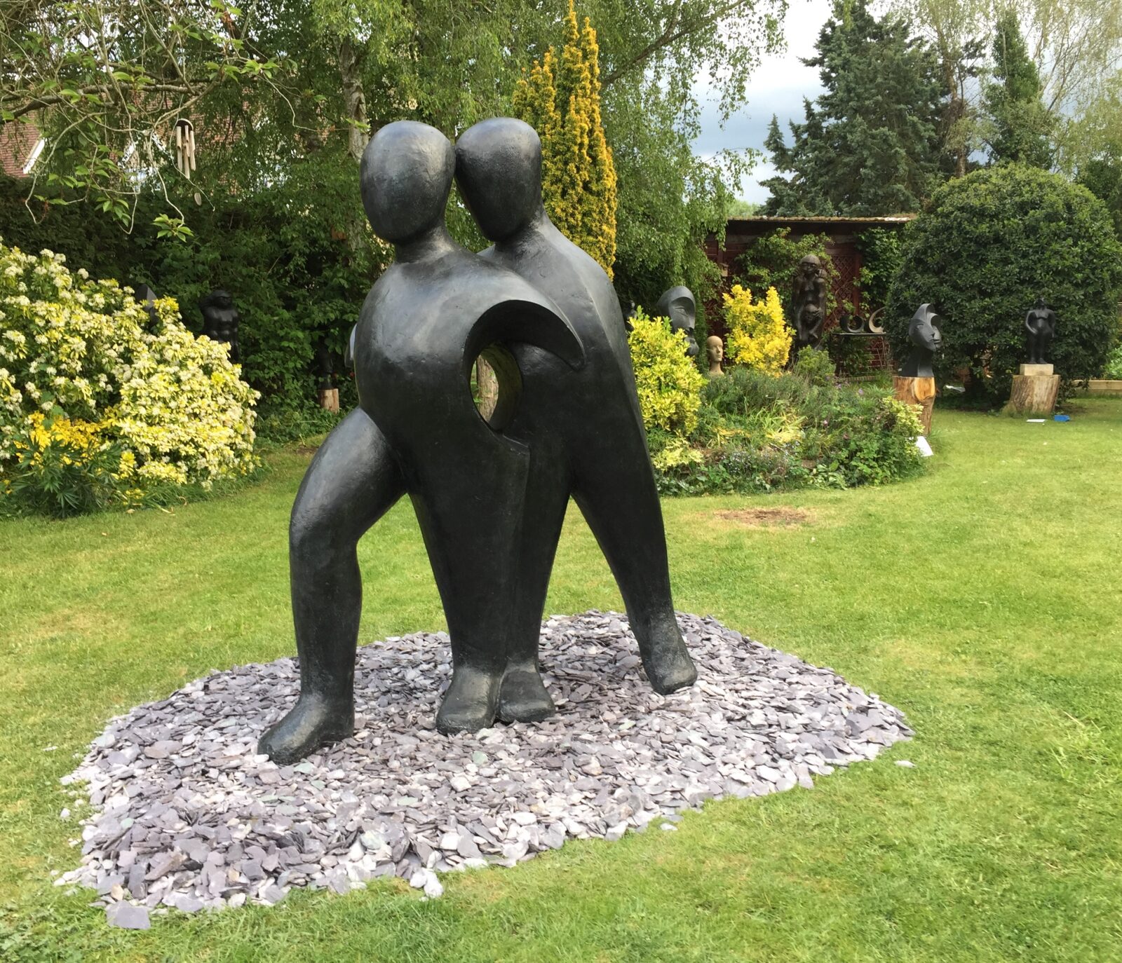 Different views of a life size sculpture of two abstracted figures for a public communal space