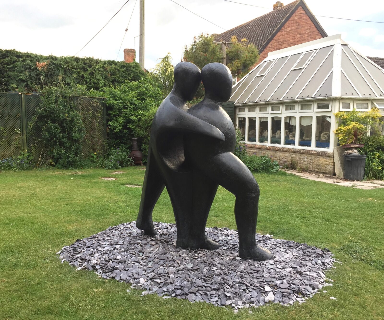 Different views of the large life size sculpture of two abstracted figures commissioned by an UK Hospital