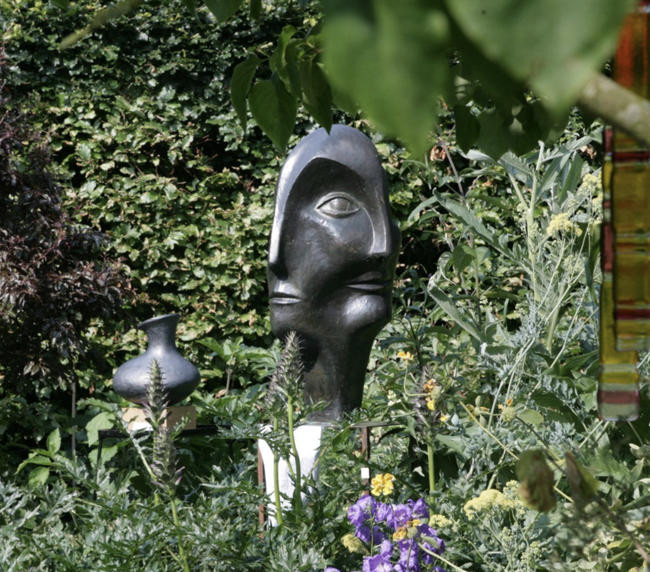 contemporary bronze sculpture of a double head for the garden
