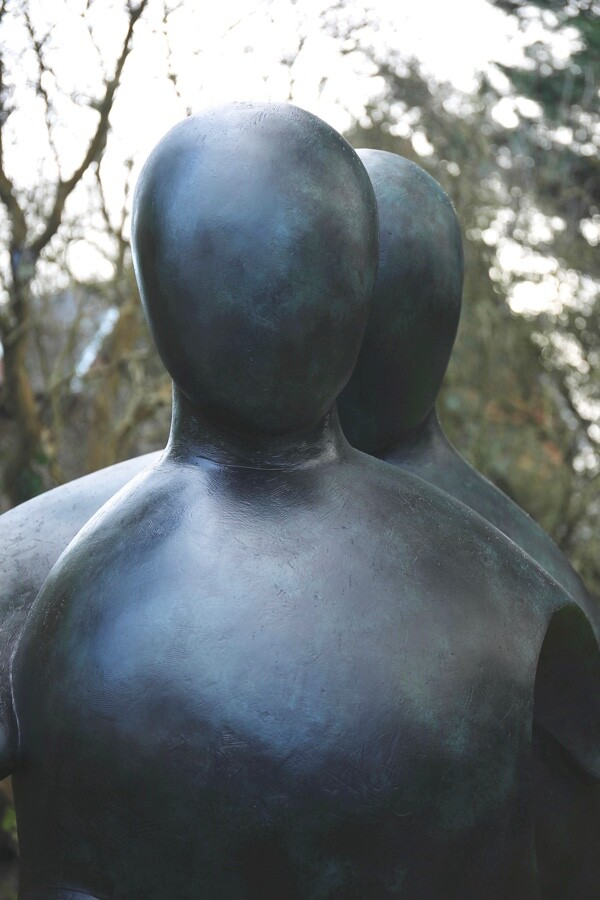 Detail of a large hospital commissioned bronze sculpture of two supportive figures