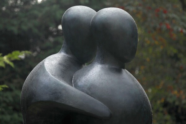 Detail of a large hospital commissioned bronze sculpture of two supportive figures