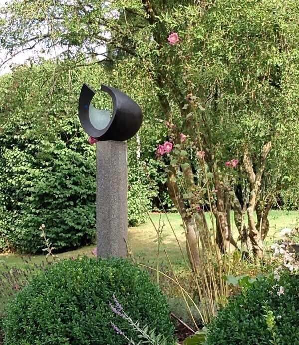 Abstract circular garden bronze sculpture coloured green and black