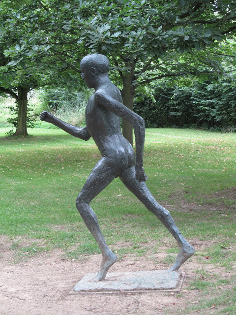 Elisabeth Frink's bronze sculpture Running Man 1 in a London park