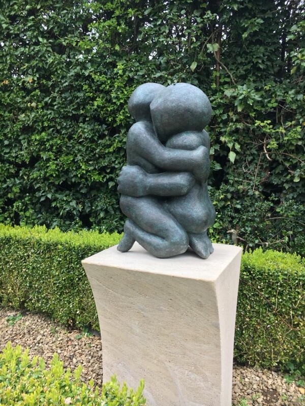 contemporary bronze sculpture of an affectionate hug suitable for a wedding anniversary