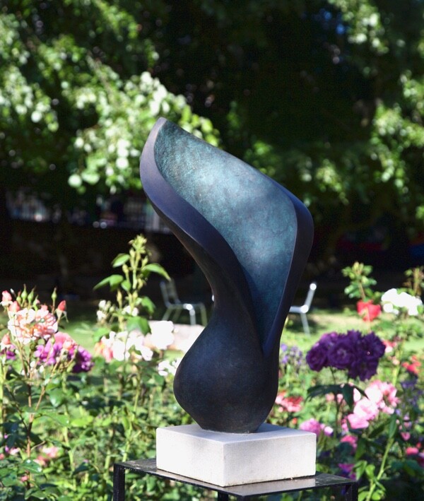 Contemporary abstract floral bronze sculpture in the rose garden