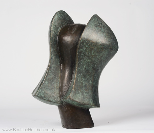 contemporary bronze sculpture of a head in green and black