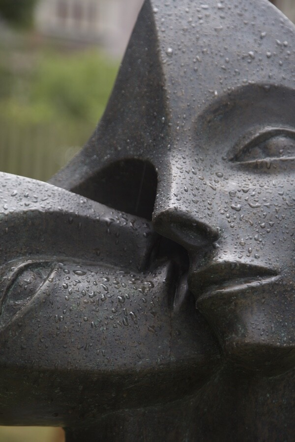Detail of contemporary garden bronze sculpture of a double head loosely based on Picasso