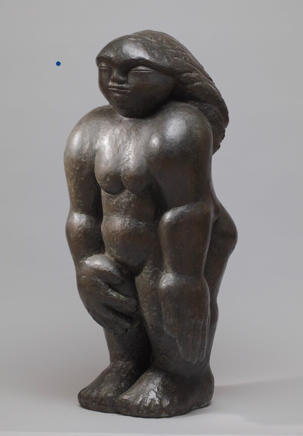 Bronze sculpture of a compact figure based on a stone carving