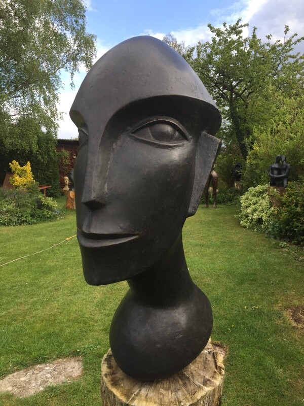 Abstract sculpture of a modern cubist head suitable as a focal point for the garden and home