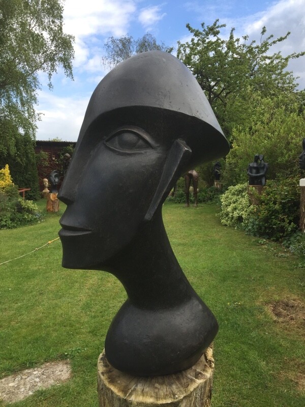 Abstract sculpture of a modern cubist head suitable as a focal point for the garden and home
