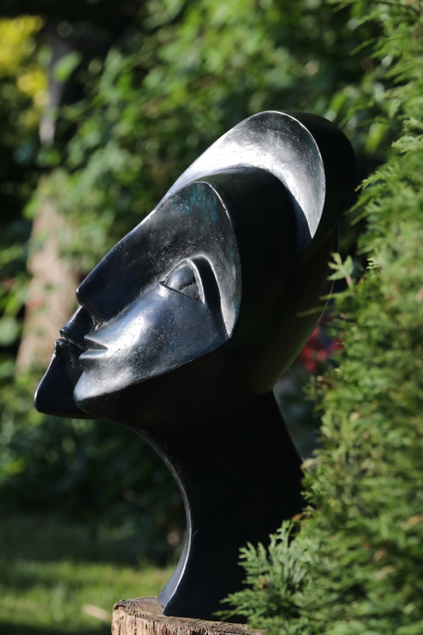 contemporary garden bronze sculpture of a double head based on Picasso