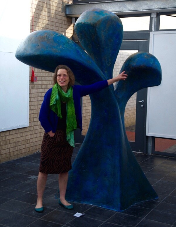 the sculptor Beatrice Hoffman with her public or corporate abstract tall blue sculpture Surging up