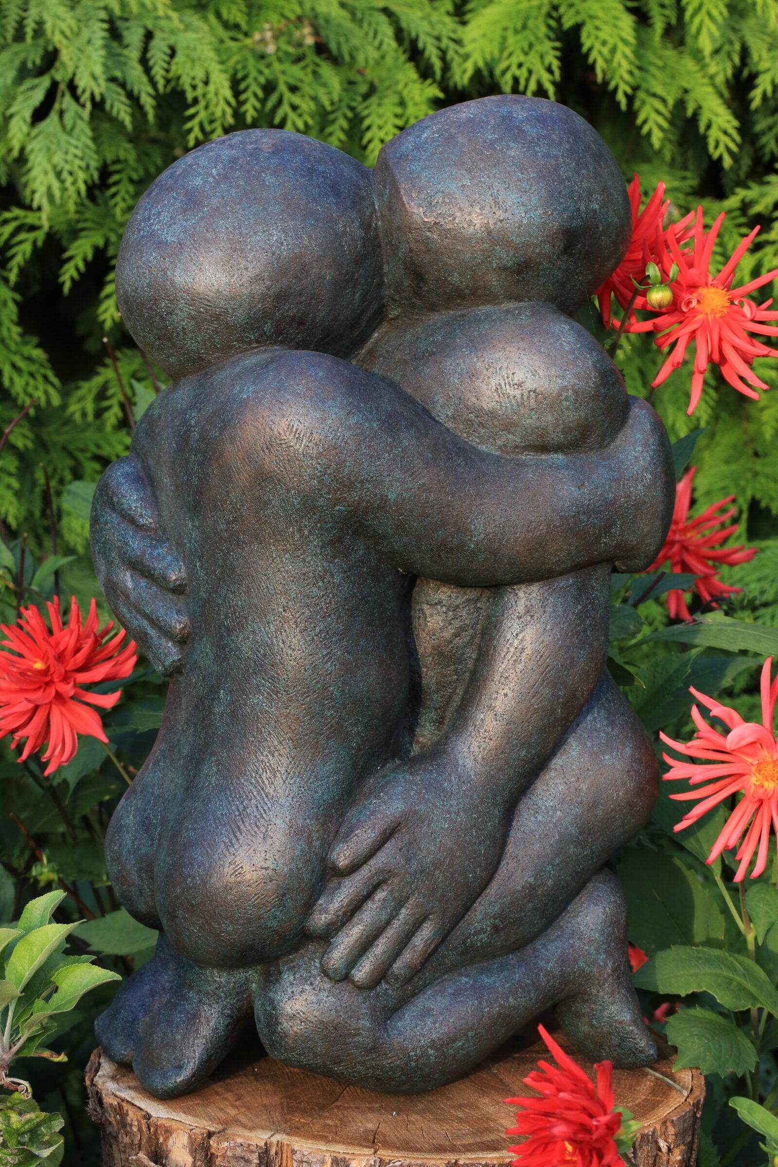 contemporary bronze sculpture of an erotical couple in the garden